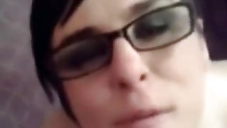 Facial brunette gets sprayed all over her glasses with cum